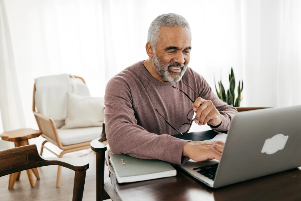Senior men taking in front of laptop