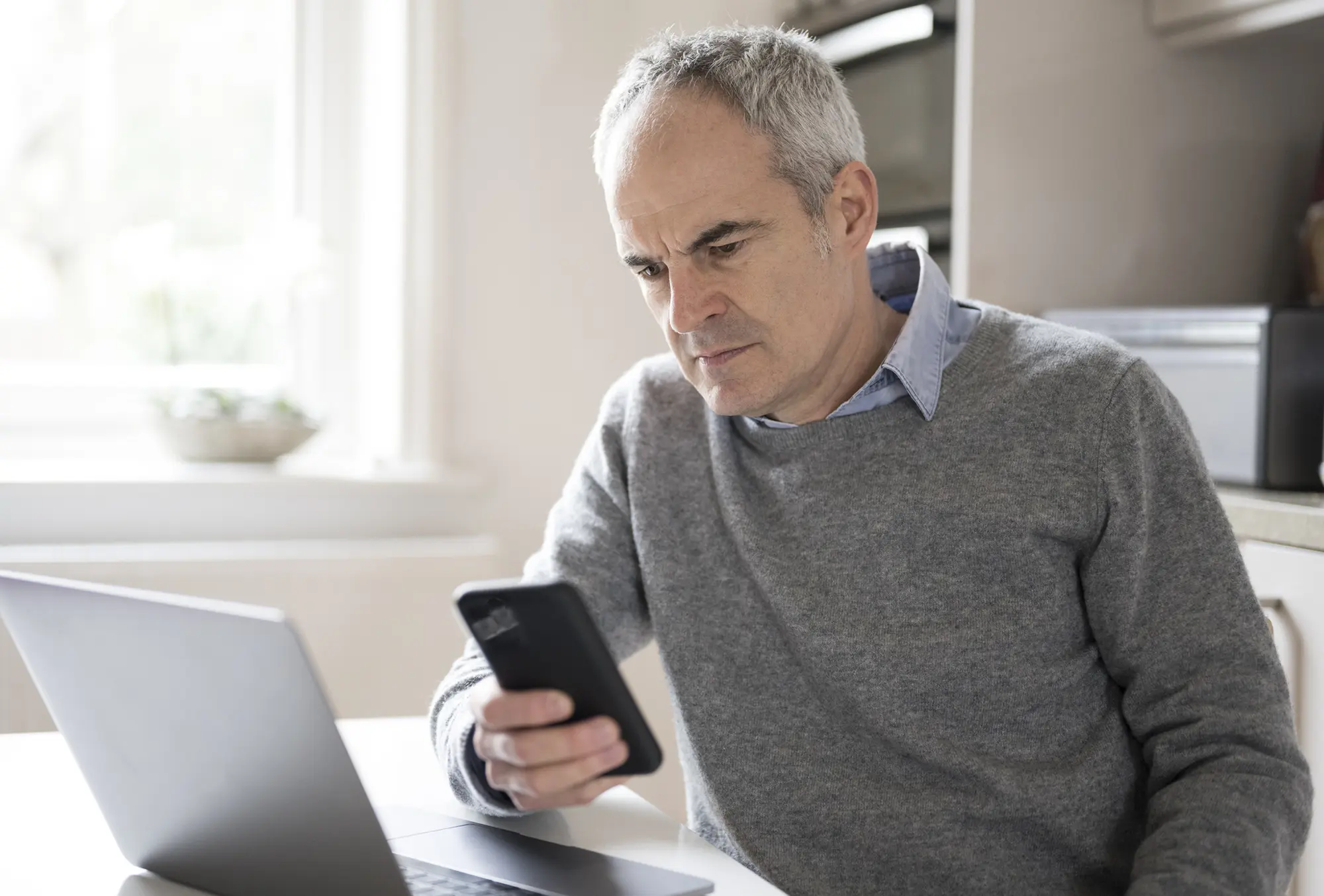 Concerned man looking at phone